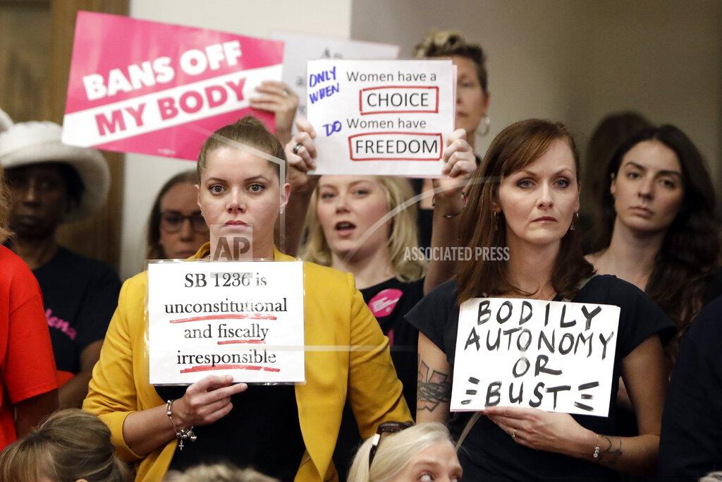 Mark Humphrey FILE - In this Aug. 12, 2019, file photo, people wait for a Senate hearing to begin to discuss a fetal heartbeat abortion ban, or possibly something more restrictive in Nashville, Tenn. The assertion by proponents that abortion as early as six weeks into pregnancy “stops a beating heart” was arguably the stroke of political genius that helped so-called “heartbeat bills” defy constitutional concerns to become law in 12 states. None has taken effect due to court challenges, the latest being argued Thursday, April 29, 2021, in Tennessee. (AP Photo/Mark Humphrey, File)