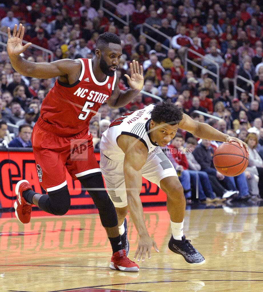 Timothy D. Easley Louisville forward Dwayne Sutton (24) drives past North Carolina State guard Eric Lockett (5) during the second half of an NCAA college basketball game in Louisville, Ky., Thursday, Jan. 24, 2019. Louisville won 84-77. (AP Photo/Timothy D. Easley)