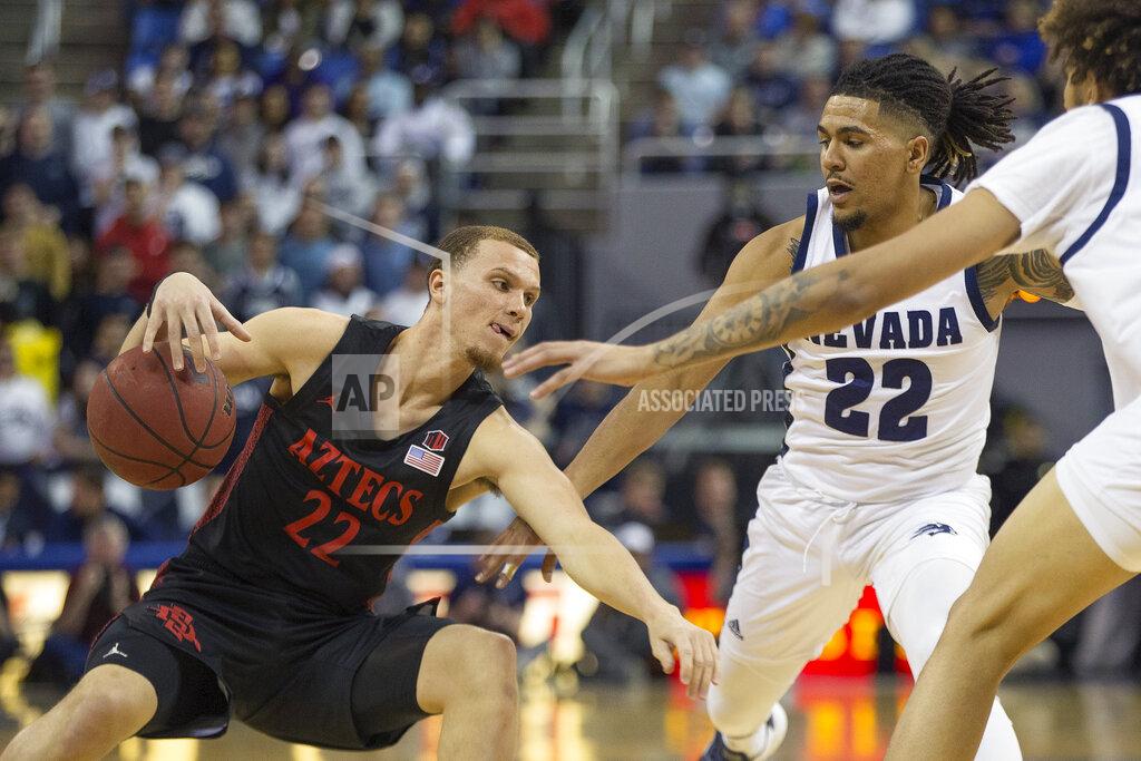 Tom R. Smedes San Diego State guard Malachi Flynn (22) slips as he drives past Nevada guard Jazz Johnson (22) during the first half of an NCAA college basketball game played at Lawlor Events Center in Reno, Nev., Saturday, Feb. 29, 2020. (AP Photo/Tom R. Smedes)