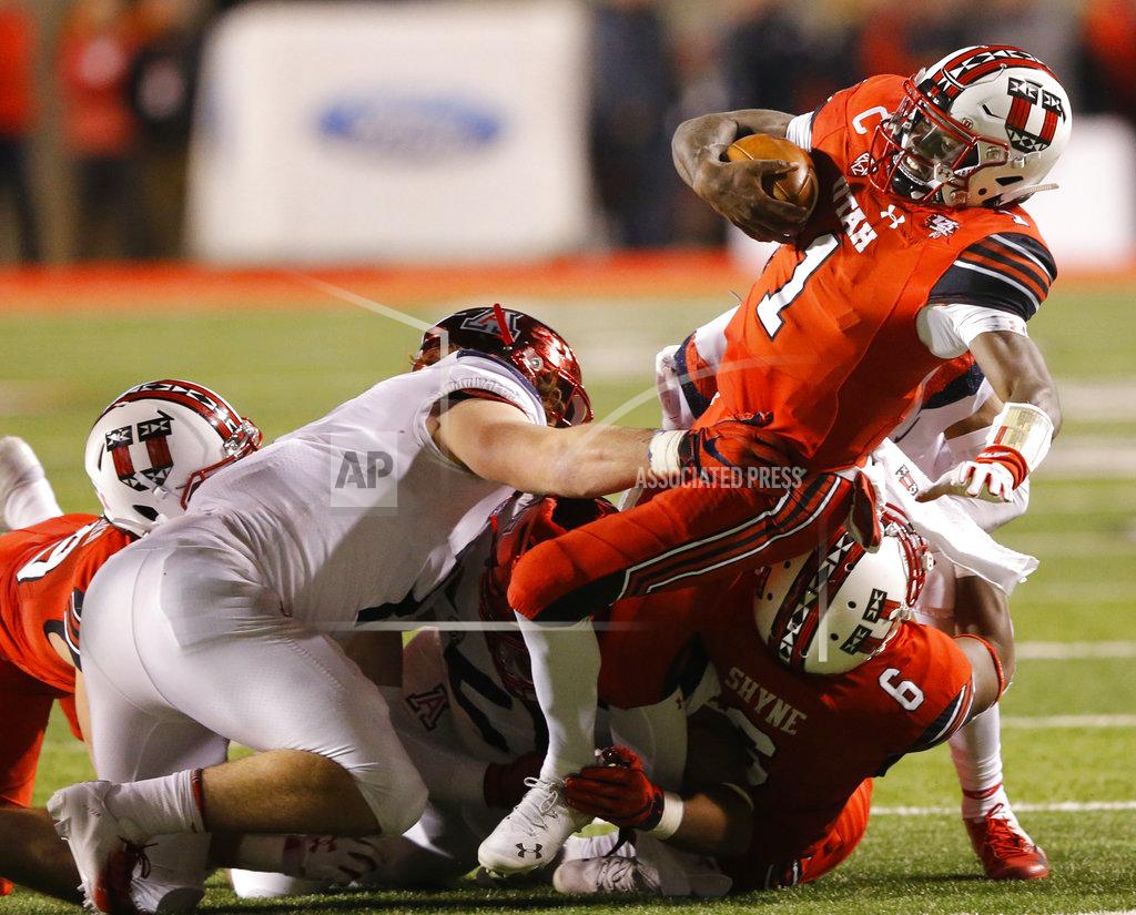Rick Bowmer Arizona linebacker Colin Schooler, left, tackles Utah quarterback Tyler Huntley (1) during the first half of an NCAA college football game Friday, Oct. 12, 2018, in Salt Lake City. (AP Photo/Rick Bowmer)