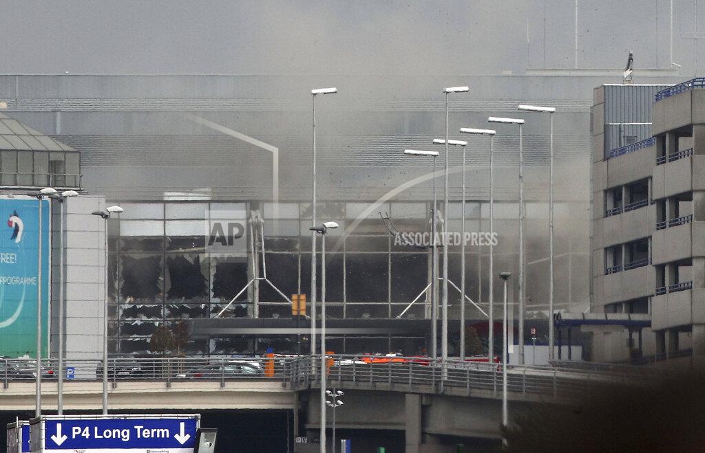 Michel Spingler FILE - In this March 22, 2016 file photo smoke billows from the Zaventem Airport in Brussels after an explosion there. Bombs struck the Brussels airport and one of the city's metro stations, killing and wounding dozens of people, as a European capital was again locked down amid heightened security threats. (AP Photo/Michel Spingler, File)