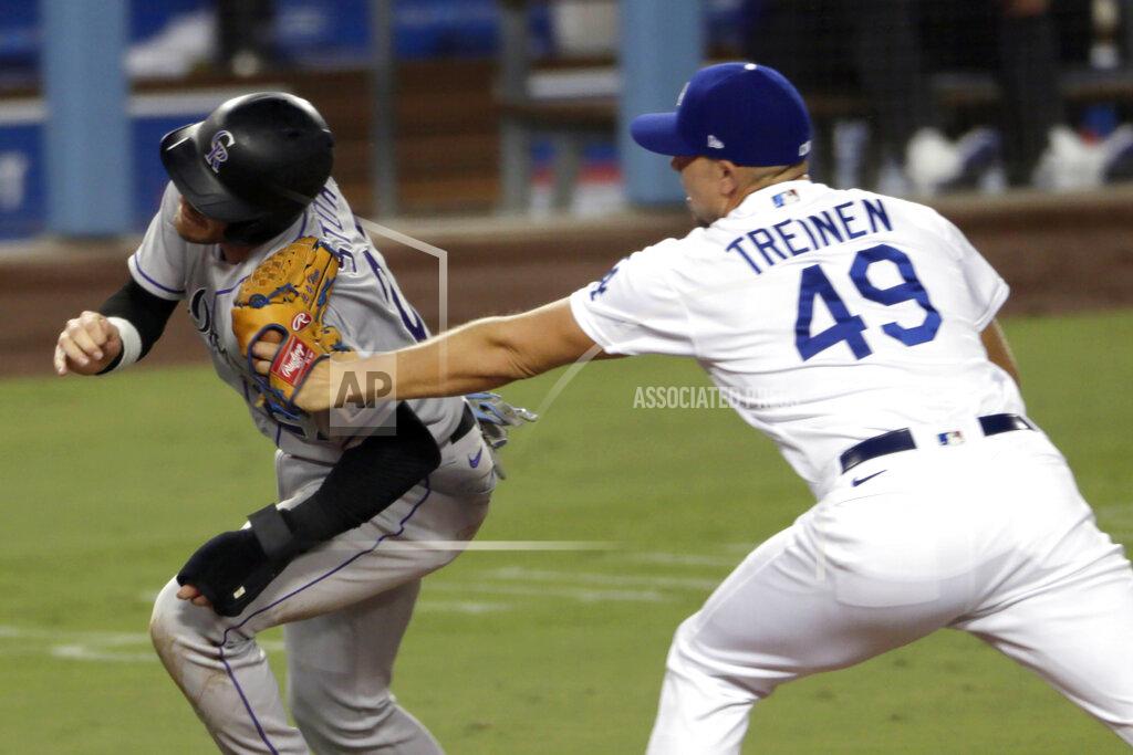 Alex Gallardo Los Angeles Dodgers relief pitcher Blake Treinen, right, tags out Colorado Rockies' Trevor Story on a rundown between third and home during the eighth inning of a baseball game in Los Angeles, Saturday, Aug. 22, 2020. (AP Photo/Alex Gallardo)