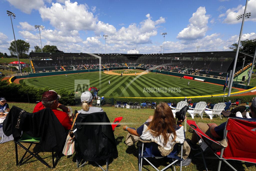 Gene J. Puskar In this Aug. 23, 2018, photo, Little League fans watch a consolation baseball game between Coeur D'Alene, Idaho and Barcelona, Spain at the Little League World Series tournament in South Williamsport, Pa. Little League has been benched. The youth baseball program that boasts more than 2.5 million kids spread over 6,500 programs in 84 countries is on hold at least until May 11 due to the corona virus pandemic. Even that target date for a return to the sports lineup seems optimistic, and the fate of its signature event, the Little League World Series in August in South Williamsport, Pennsylvania is unclear. (AP Photo/Gene J. Puskar)