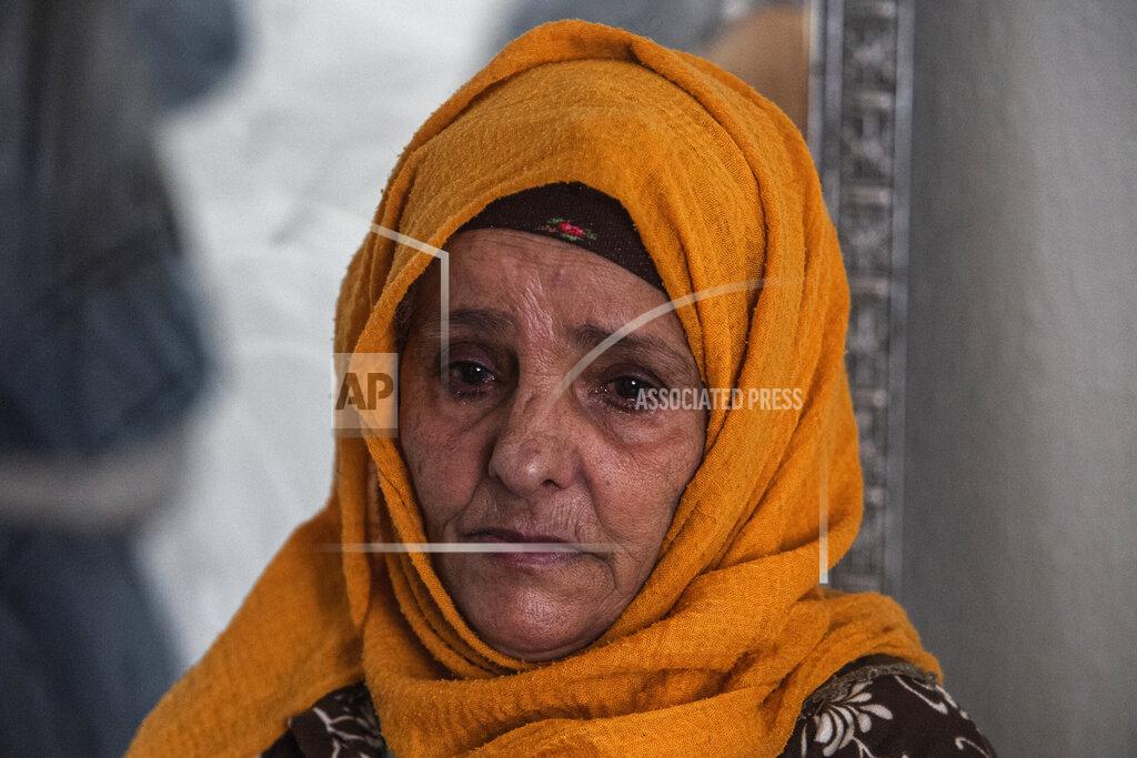 Riadh Dridi Zina Sehi looks at her son, Hosni Kalaia, in Kasserine, Tunisia, Friday, Dec.11, 2020. Hundreds of desperate Tunisians have set themselves on fire in the past 10 years as an act of protest. In 2014, Sehi, now 68, tried to burn herself to death in front of the president’s palace in Tunis, protesting the government’s lack of financial support for the family. (AP Photo/Riadh Dridi)