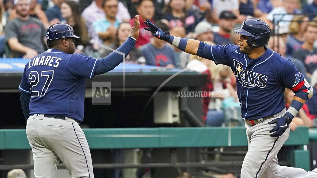 Tony Dejak Tampa Bay Rays' Nelson Cruz, right, is congratulated by third base coach Rodney Linares after Cruz hit a solo home run during the third inning of a baseball game Friday, July 23, 2021, in Cleveland. (AP Photo/Tony Dejak)