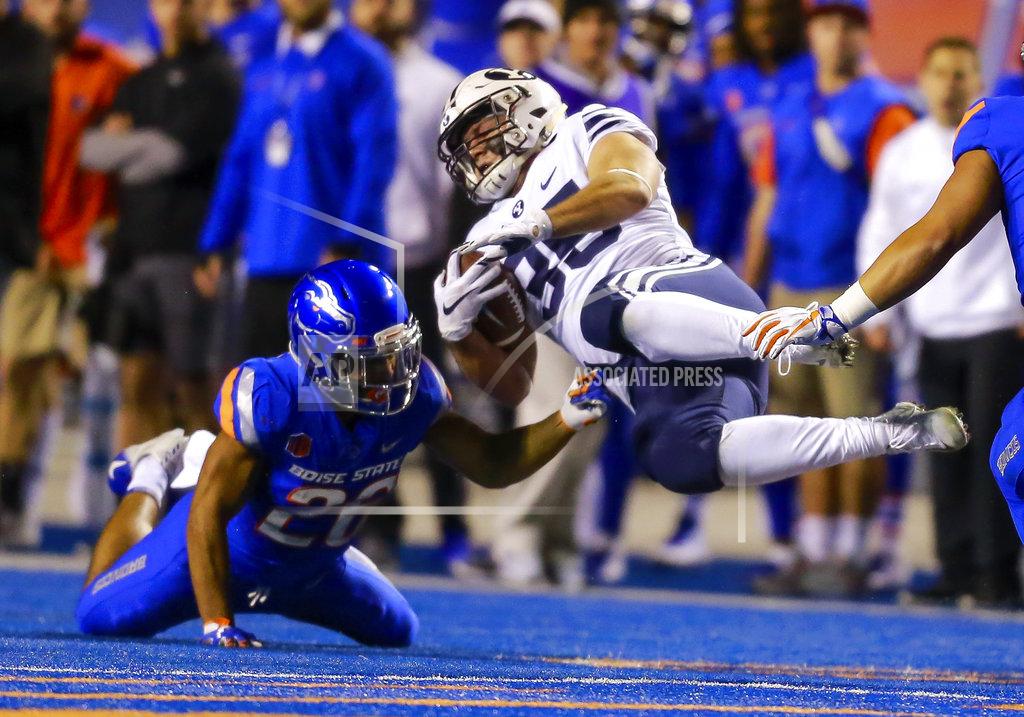 Steve Conner BYU running back Brayden El-Bakri (35) is spun to the ground after being hit by Boise State cornerback Avery Williams (26) during the first half of an NCAA college football game Saturday, Nov. 3, 2018, in Boise, Idaho. (AP Photo/Steve Conner)