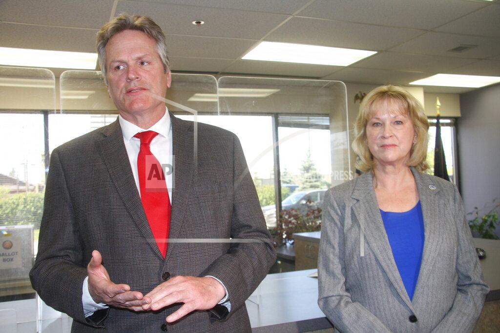 Mark Thiessen Alaska Gov. Mike Dunleavy, left, answers a reporter's question after he and his running mate, Nancy Dahlstrom, right, filed as candidates on Monday, May 23, 2022, at the Alaska Division of Elections office in Anchorage, Alaska. Dahlstrom was chosen by Dunleavy to be his running mate in the 2022 election after current Lt. Gov. Kevin Meyer did not seek re-election. (AP Photo/Mark Thiessen)