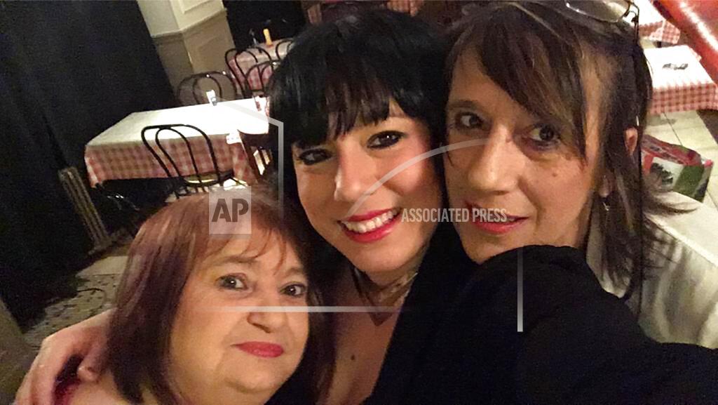 In this photo provided by Raquel Magalhaes, Viviane Bouculat, left, celebrates the New Year in 2018 with her friends Raquel Magalhaes, center, and Bernadette Marie. They jokingly called themselves "The Three Bad Girls." For three decades, Viviane Bouculat was the owner, cook and beating heart of l’Annexe. Anyone was welcome, but over the years it became a haven for local artists, actors and musicians. Bouculat died March 31, 2020 of coronavirus. She was 65. (Raquel Magalhaes via AP)