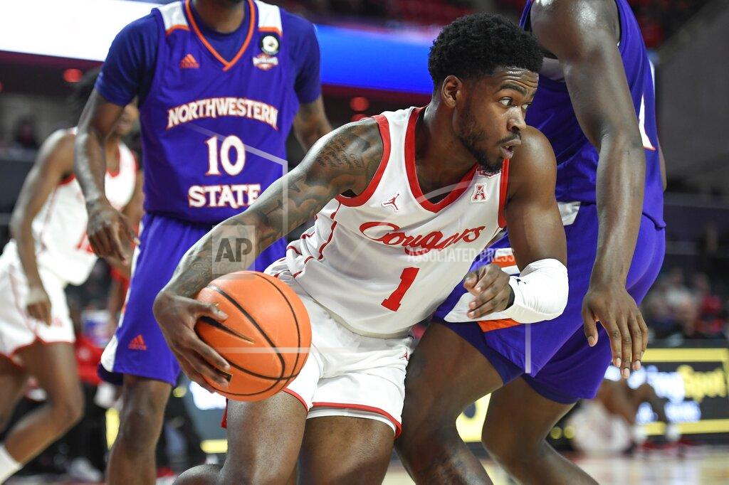 Justin Rex Houston guard Jamal Shead (1) works past a Northwestern State defender during the first half of an NCAA college basketball game Tuesday, Nov. 30, 2021, in Houston. (AP Photo/Justin Rex)