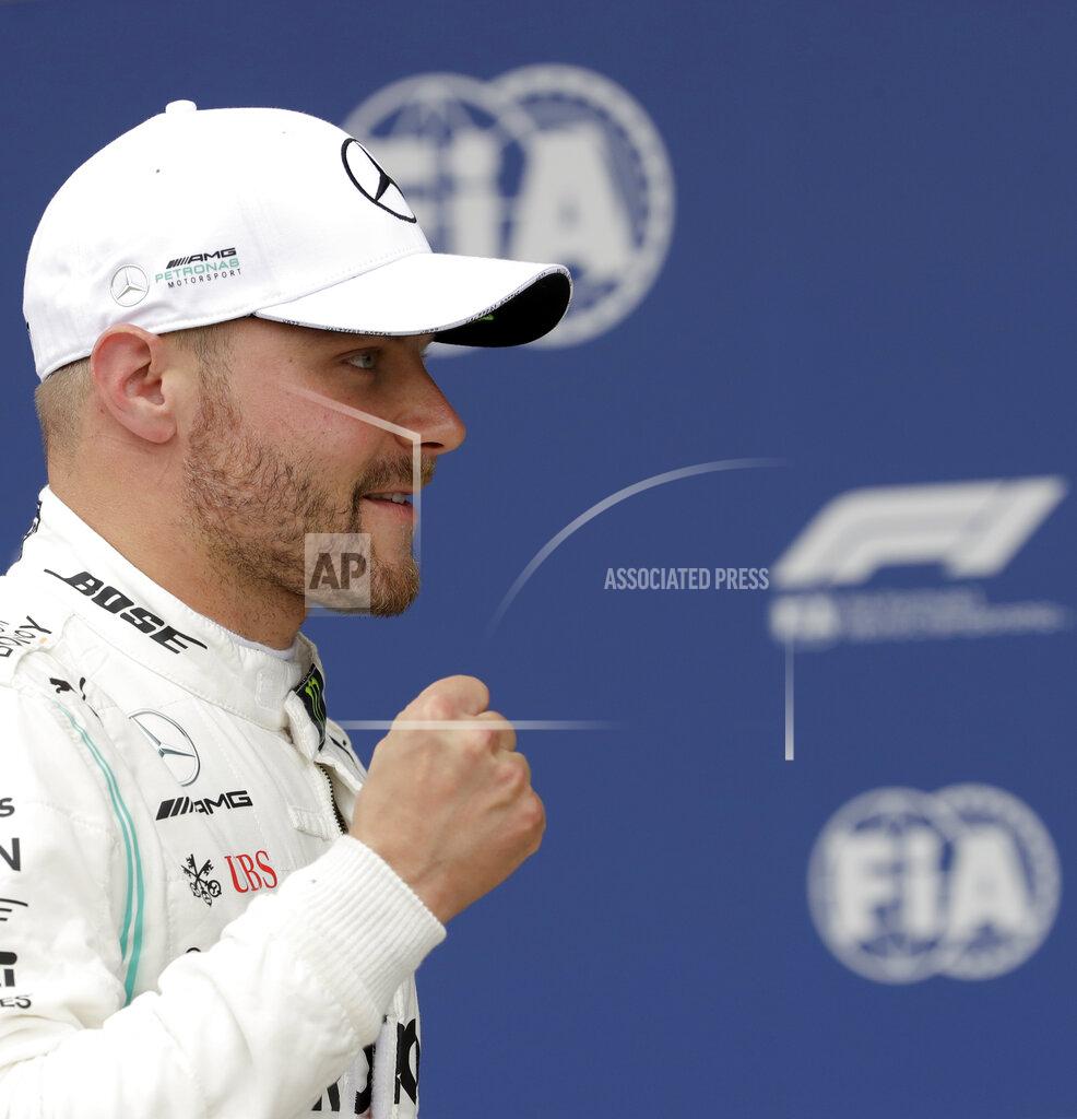 Luca Bruno Mercedes driver Valtteri Bottas of Finland celebrates after he clocked the fastest time during the qualifying session at the Silverstone racetrack, in Silverstone, England, Saturday, July 13, 2019. The British Formula One Grand Prix will be held on Sunday. (AP Photo/Luca Bruno)