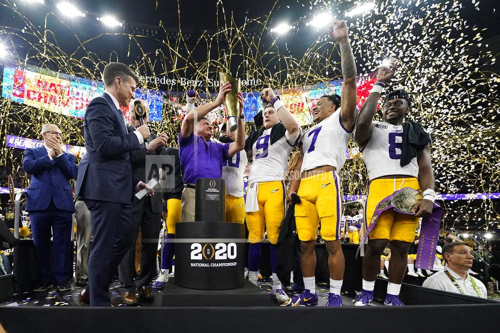 David J. Phillip LSU head coach Ed Orgeron holds the trophy after their win against Clemson in a NCAA College Football Playoff national championship game Monday, Jan. 13, 2020, in New Orleans. LSU won 42-25.(AP Photo/David J. Phillip)