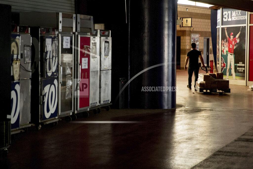 Andrew Harnik A poster of Washington Nationals pitcher Max Scherzer (31) is visible as an employee walks through the empty concourse while the Washington Nationals hold their first training camp workout at Nationals Stadium, Friday, July 3, 2020, in Washington. (AP Photo/Andrew Harnik)