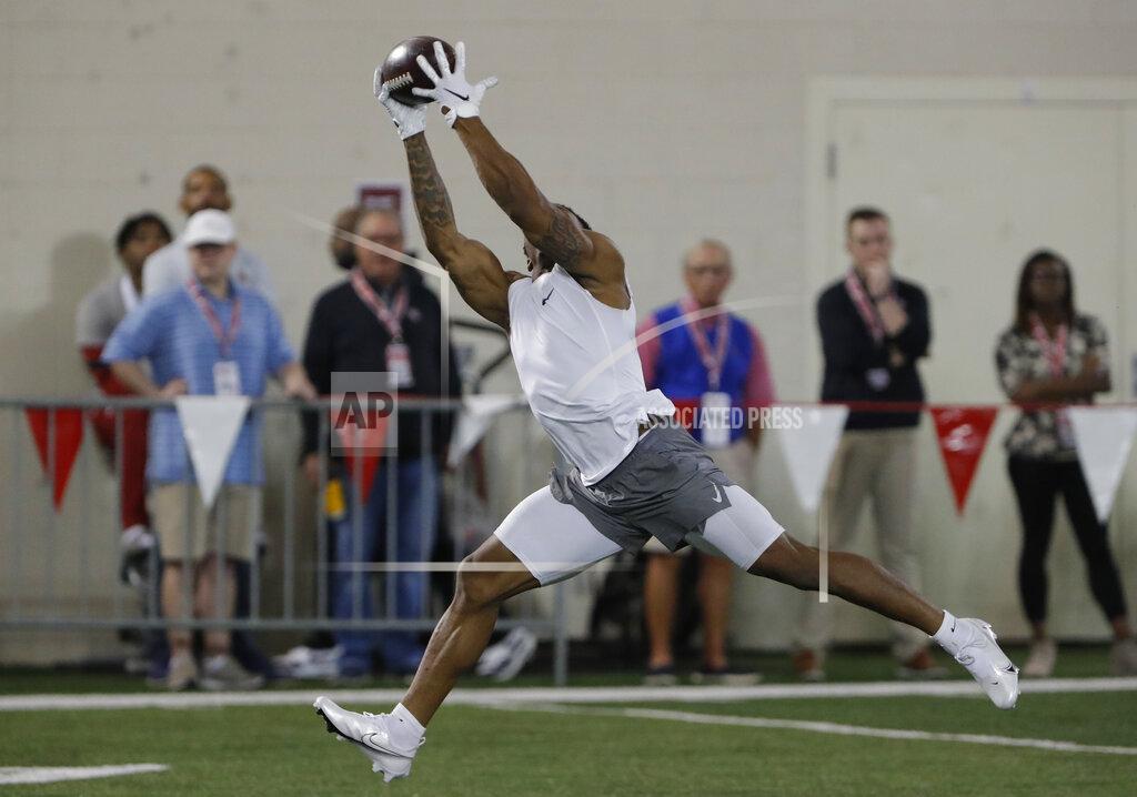 Former Oklahoma running back Marcelias Sutton makes a catch as he runs through drills during Pro Day for NFL football scouts and coaches in Norman, Okla., Wednesday, March 11, 2020. (AP Photo/Alonzo Adams)