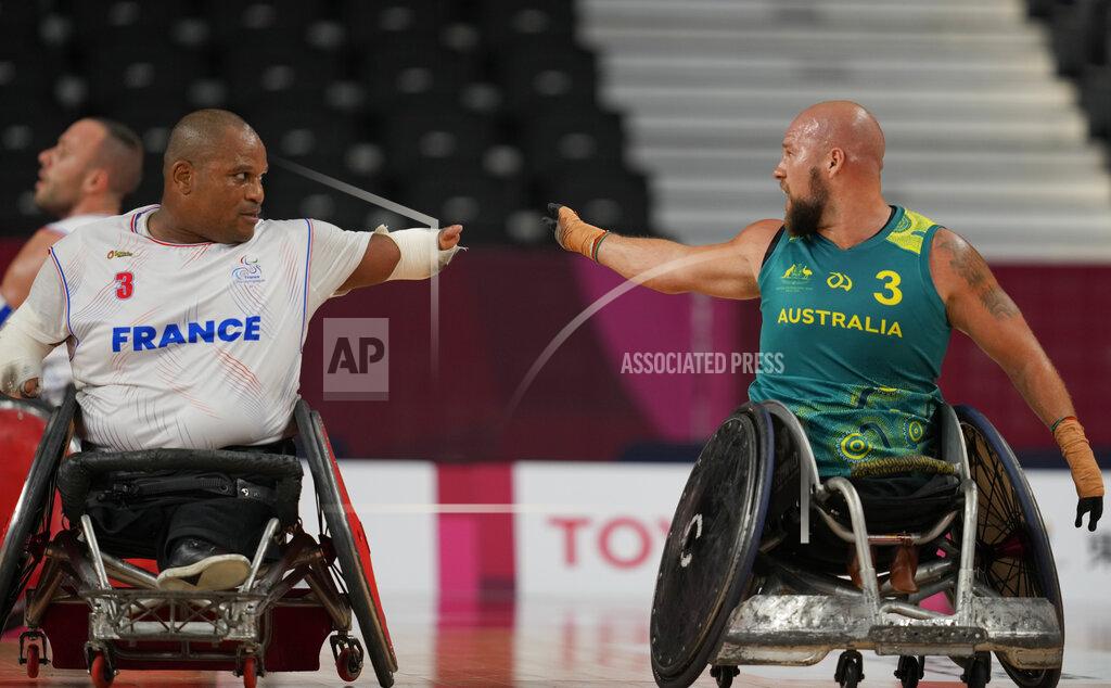 Shuji Kajiyama France's Cedric Nankin, left, and Australia's Ryley Batt chat during a Wheelchair Rugby pool match at the Tokyo 2020 Paralympic Games, Thursday, Aug. 26, 2021, in Tokyo, Japan. There are 4,403 Paralympic athletes competing in Tokyo, each with unique differences that have to be classified. Lines have to be draw, in the quest for fairness, to group similar impairments, or impairments that yield similar results. (AP Photo/Shuji Kajiyama)