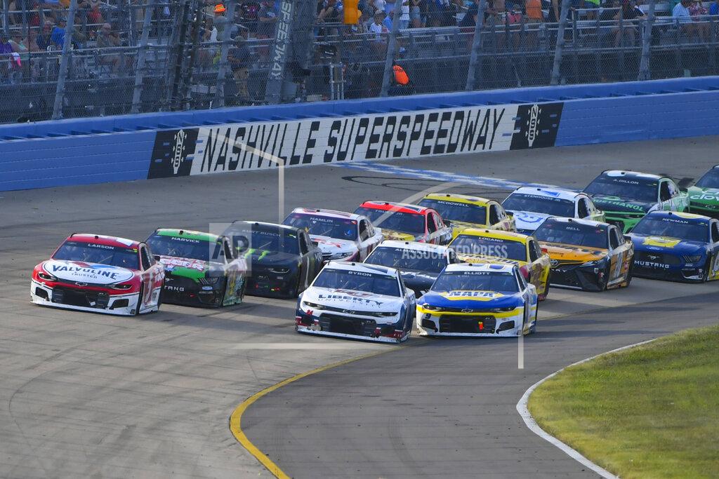 Kyle Larson, far left, and William Byron lead as Chase Elliott, front right, goes low to try to pass during a NASCAR Cup Series auto race Sunday, June 20, 2021, in Lebanon, Tenn. (AP Photo/John Amis)