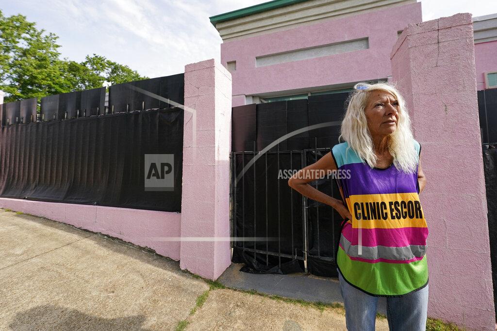 Rogelio V. Solis FILE - Derenda Hancock, co-organizer of the "Pink House Defenders," stands outside the Jackson Women's Health Organization, Mississippi's last remaining abortion clinic, also known as the "Pink House", May 3, 2022, in Jackson, Miss. Mississippi is one of the poorest states in the nation, and women would face even steeper hurdles to have access to abortion — arranging time off work, finding ways to pay for travel and lodging and, in many cases, arranging for child care while they are gone. (AP Photo/Rogelio V. Solis, File)