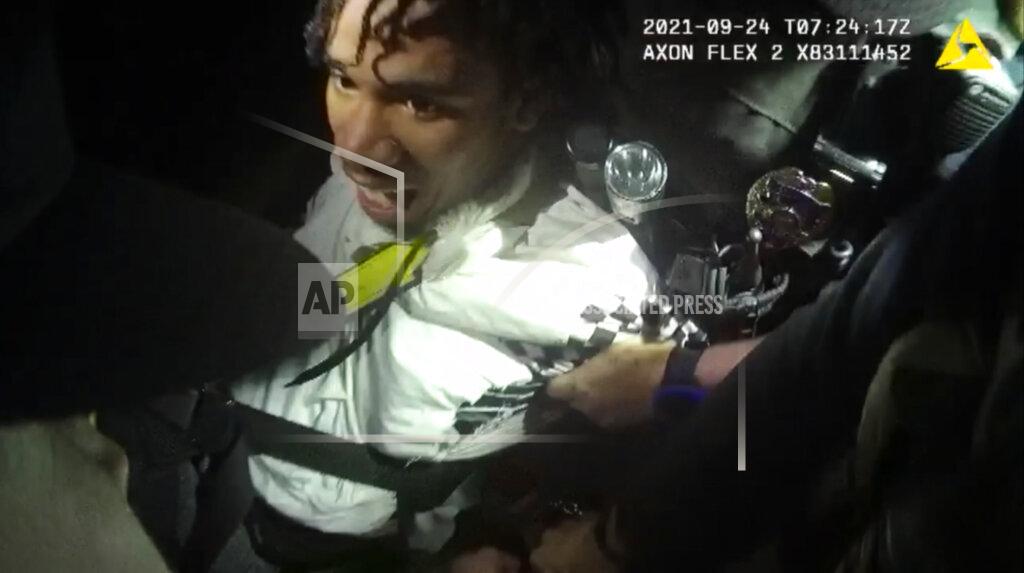 Uncredited In this image from body camera video provided by Sedgwick County, Cedric “C.J.” Lofton, 17, growls and bites at police outside his home in Wichita, Kan., on Sept. 24, 2021. His foster father said when Cedric returned from the funeral of his grandmother in September, “it got progressively worse,” according to a prosecutor’s report. He described him as “paranoid.” (Sedgwick County via AP)