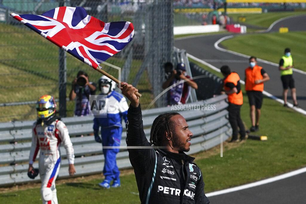 Jon Super Mercedes driver Lewis Hamilton of Britain celebrates after winning the British Formula One Grand Prix, at the Silverstone circuit, in Silverstone, England, Sunday, July 18, 2021. (AP Photo/Jon Super)
