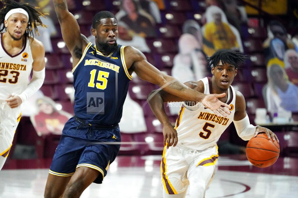 Jim Mone Michigan's Chaundee Brown (15) defends as Minnesota's Marcus Carr (5) drives the ball in the first half an NCAA college basketball game, Saturday, Jan. 16, 2021, in Minneapolis. (AP Photo/Jim Mone)