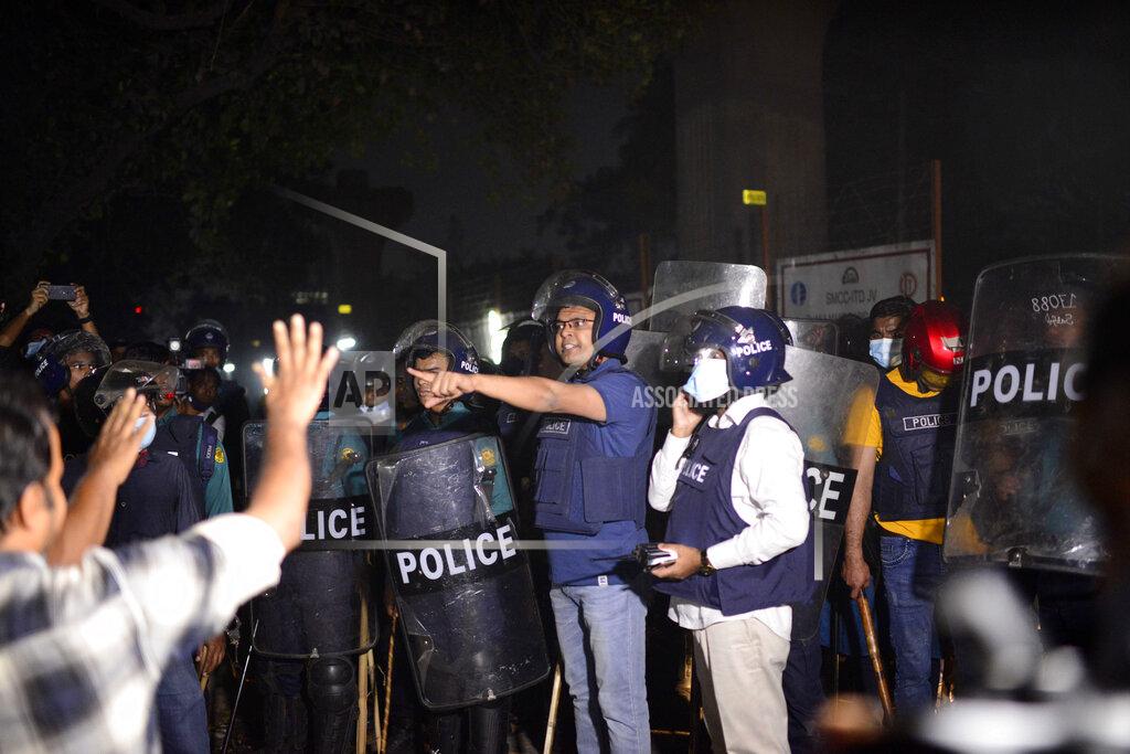Mahmud Hossain Opu Policemen confront demonstrators protest the death in prison of a writer who was arrested on charges of violating the sweeping digital security, in Dhaka, Bangladesh, Friday, Feb. 26, 2021. Mushtaq Ahmed, 53, was arrested in Dhaka in May last year for making comments on social media that criticized the Prime Minister Sheikh Hasina government's handling of the coronavirus pandemic. He had been denied bail at least six times. (AP Photo/Mahmud Hossain Opu)