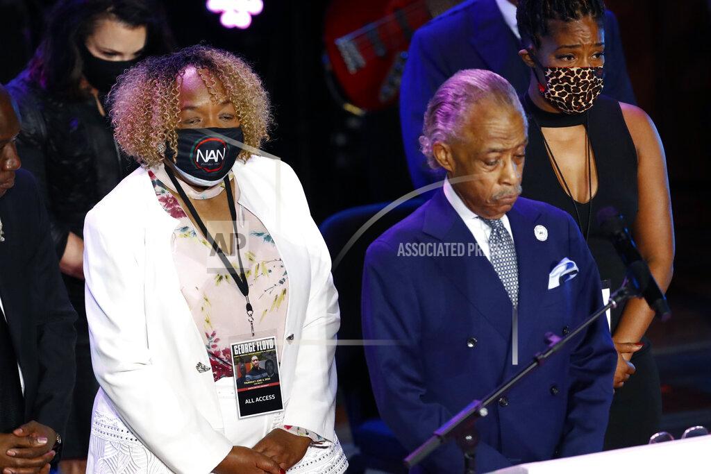 Julio Cortez Eric Garner's mother, Gwen Carr left, joins the Rev. Al Sharpton, center and entertainer Tiffany Haddish left on stage for 8 minutes, 46 seconds of silence during a memorial service for George Floyd at North Central University Thursday, June 4, 2020, in Minneapolis. (AP Photo/Julio Cortez)