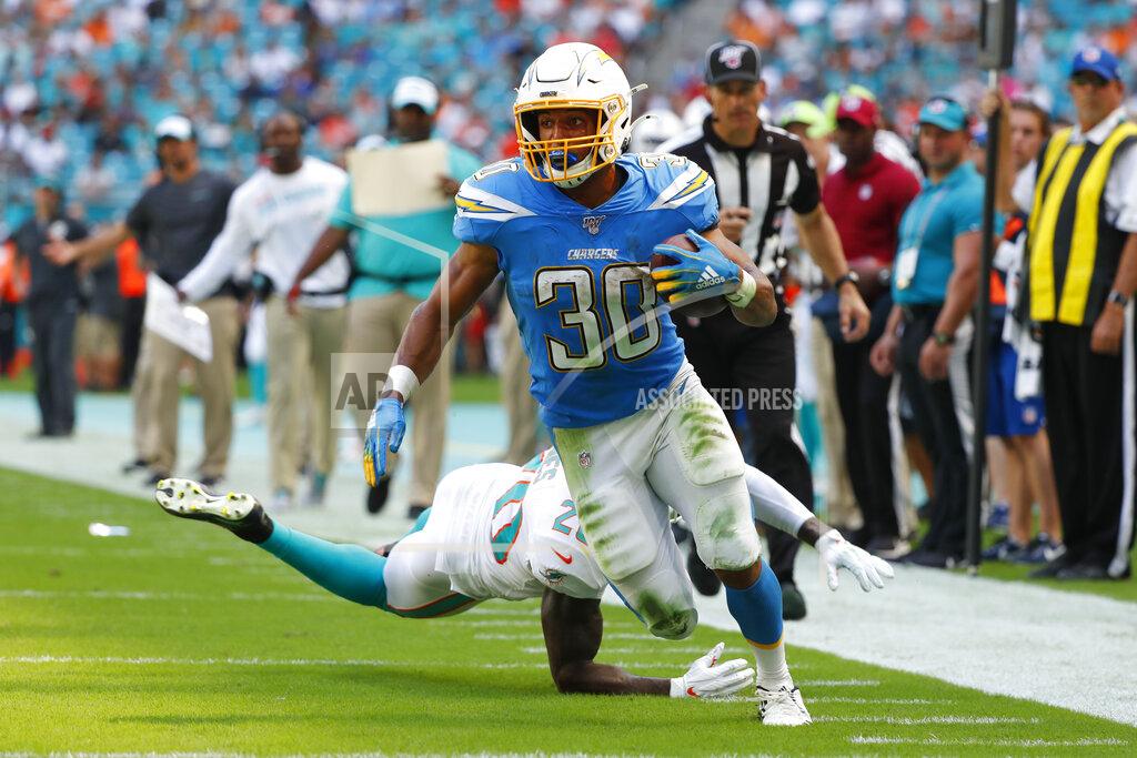 Wilfredo Lee Miami Dolphins free safety Reshad Jones (20) misses a tackles as Los Angeles Chargers running back Austin Ekeler (30) runs for a touchdown, during the first half at an NFL football game against the Miami Dolphins, Sunday, Sept. 29, 2019, in Miami Gardens, Fla. (AP Photo/Wilfredo Lee)