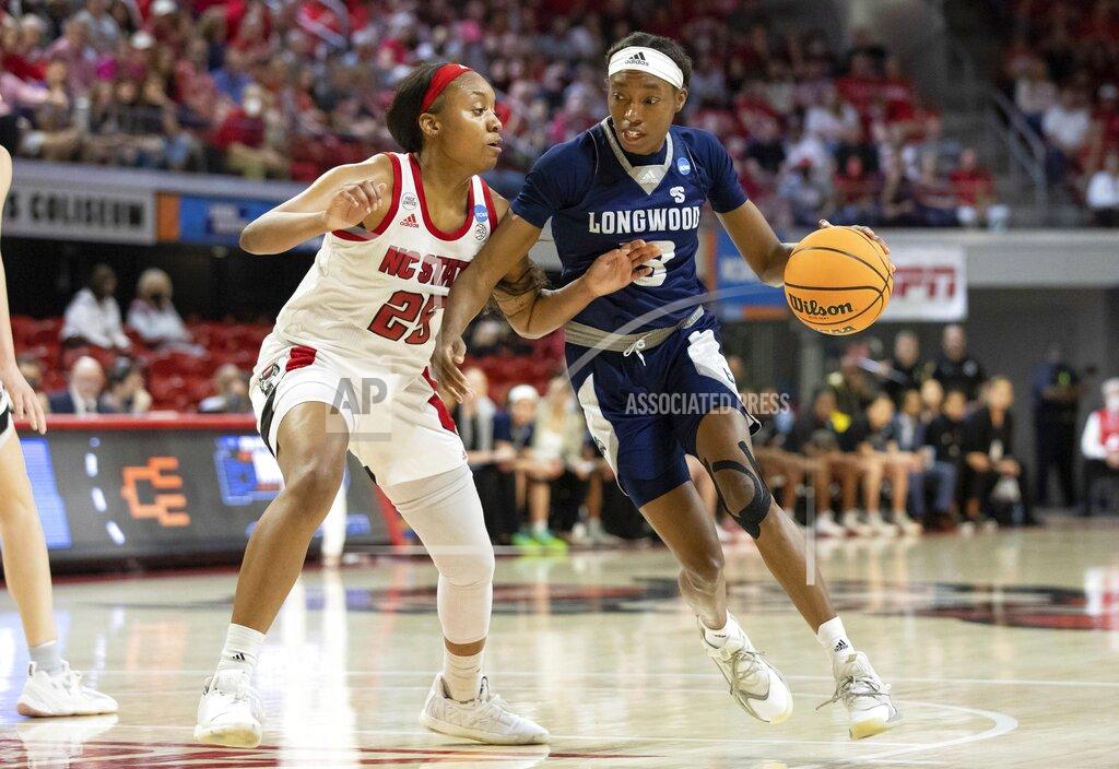 Ben Mckeown Longwood's Akila Smith (13) drives against North Carolina State's Kayla Jones (25) during the first half of a college basketball game in the first round of the NCAA tournament in Raleigh, N.C., Saturday, March 19, 2022. (AP Photo/Ben McKeown)