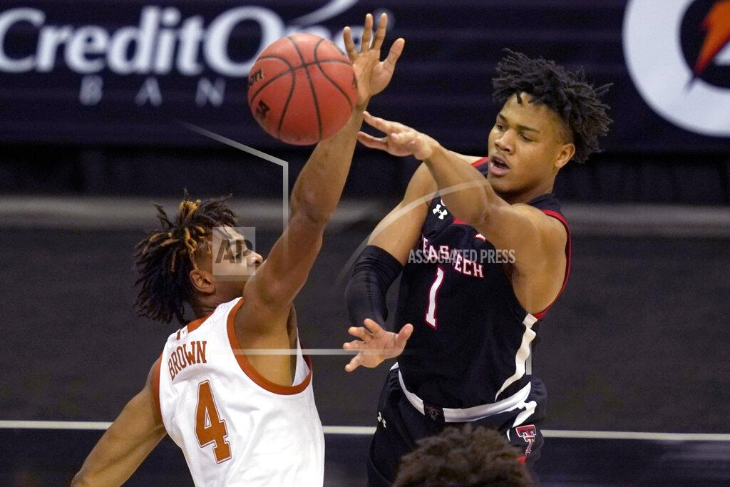 Orlin Wagner Texas Tech guard Terrence Shannon Jr. (1) passes while covered by Texas forward Greg Brown (4) during the second half of an NCAA college basketball game in the quarterfinal round of the Big 12 men's tournament in Kansas City, Mo., Thursday, March 11, 2021. (AP Photo/Orlin Wagner)