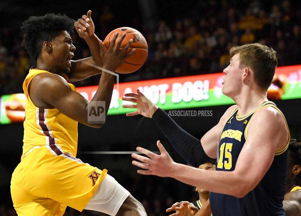 Hannah Foslien Minnesota's Marcus Carr, left, loses the ball against Michigan's Jon Teske (15) in the first half during an NCAA college basketball game on Sunday, Jan. 12, 2020, in Minneapolis. (AP Photo/Hannah Foslien)