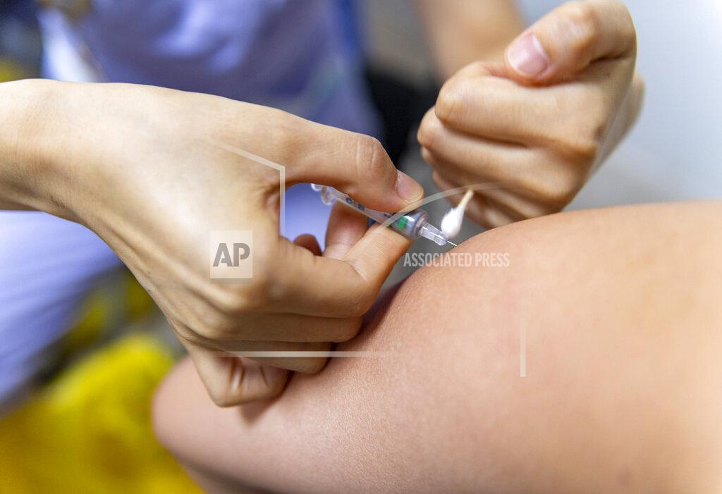 Chen Xinbo ADDS VACCINE MANUFACTURE’S NAME - In this photo released by Xinhua News Agency, a medical worker administers a Sinopharm's COVID-19 vaccine at the Jingcheng Hospital in Ruili city in southwestern China's Yunnan Province Thursday, April 1, 2021. The Chinese border city hit by a fresh outbreak of COVID-19 this week began a five-day drive Friday to vaccinate its entire population of 300,000 people. (Chen Xinbo/Xinhua via AP)
