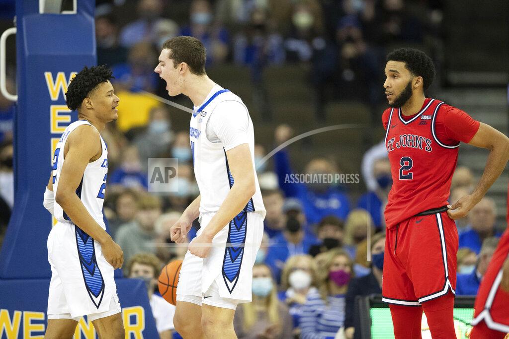 Rebecca S. Gratz St. John's Julian Champagnie (2) stands by as Creighton's Trey Alexander, left, and Ryan Kalkbrenner, center, celebrate after Alexander made a basket and drew the foul during the second half of an NCAA college basketball game Wednesday, Jan. 19, 2022, in Omaha, Neb. Creighton defeated St. John's 87-64. (AP Photo/Rebecca S. Gratz)