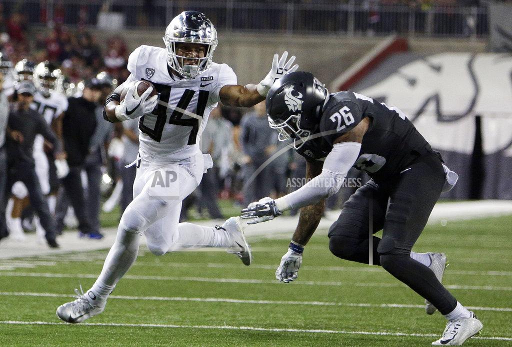 Young Kwak Oregon running back CJ Verdell (34) runs the ball while defended by Washington State safety Skyler Thomas (25) during the second half of an NCAA college football game in Pullman, Wash., Saturday, Oct. 20, 2018. Washington State won 34-20. (AP Photo/Young Kwak)