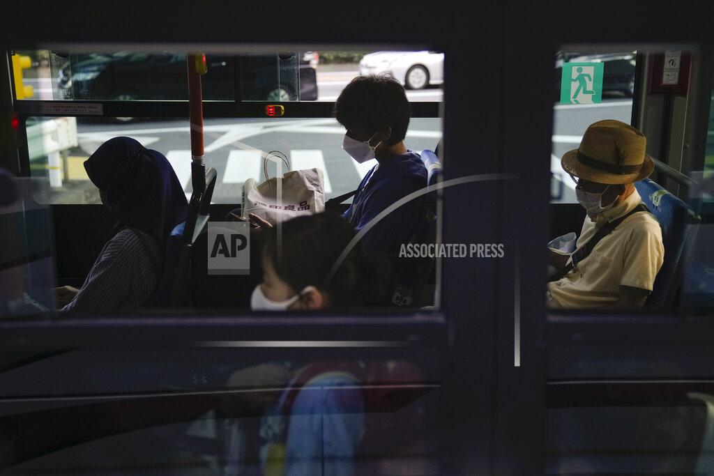 Jae C. Hong Commuters sit in a bus ahead of the 2020 Summer Olympics, Friday, July 16, 2021, in Tokyo. (AP Photo/Jae C. Hong)