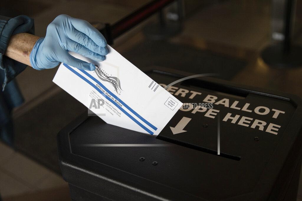 Matt Rourke A voter cast her mail-in ballot at in a drop box in West Chester, Pa., prior to the primary election, Thursday, May 28, 2020. (AP Photo/Matt Rourke)