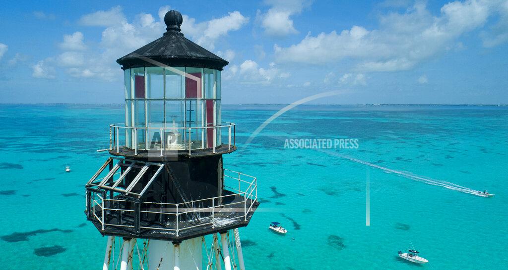 Andy Newman This aerial photo provided by the Florida Keys News Bureau shows boats with snorkelers anchored around Alligator Reef Lighthouse, Tuesday, Sept. 7, 2021, off Islamorada, Fla., in the Florida Keys. On Tuesday, officials from the Islamorada-based Friends of the Pool, Inc., announced that U.S. Secretary of the Interior Deb Haaland approved a recommendation from the National Park Service that the organization be granted ownership of the lighthouse under the National Historic Lighthouse Preservation Act. Friends of the Pool hopes to raise about $9 million to preserve the almost 150-year-old structure. (Andy Newman/Florida Keys News Bureau via AP)