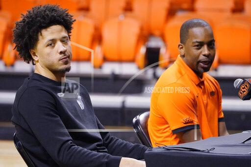 Sue Ogrocki Cade Cunningham, left, and Oklahoma State head coach Mike Boynton Jr., right, announce that Cunningham will enter the NBA draft after a dynamic freshman season that saw him named a first-team AP All-American, Thursday, April 1, 2021, in Stillwater, Okla. (AP Photo/Sue Ogrocki)