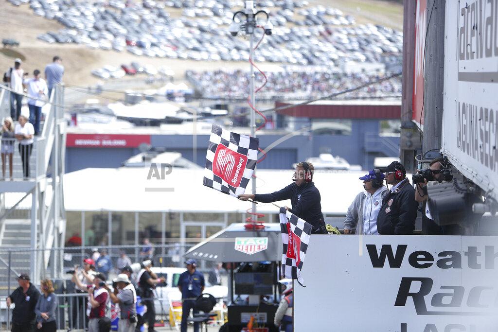 Elias Funez The checkered flag is waved at the end of the Firestone Grand Prix of Monterey Sunday at Laguna Seca.(Elias Funez/The Union via AP)
