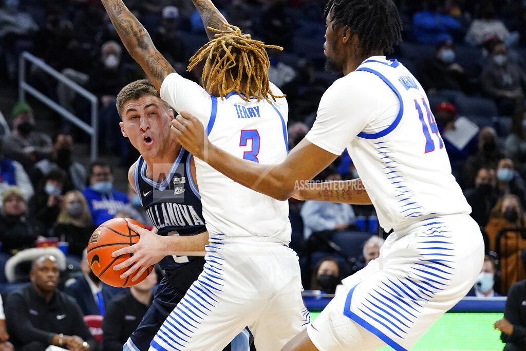 Nam Y. Huh Villanova guard Collin Gillespie, left, looks to pass against DePaul guard Jalen Terry, center, and DePaul center Nick Ongenda during the first half of an NCAA college basketball game in Chicago, Saturday, Jan. 8, 2022. Villanova won 79-64. (AP Photo/Nam Y. Huh)