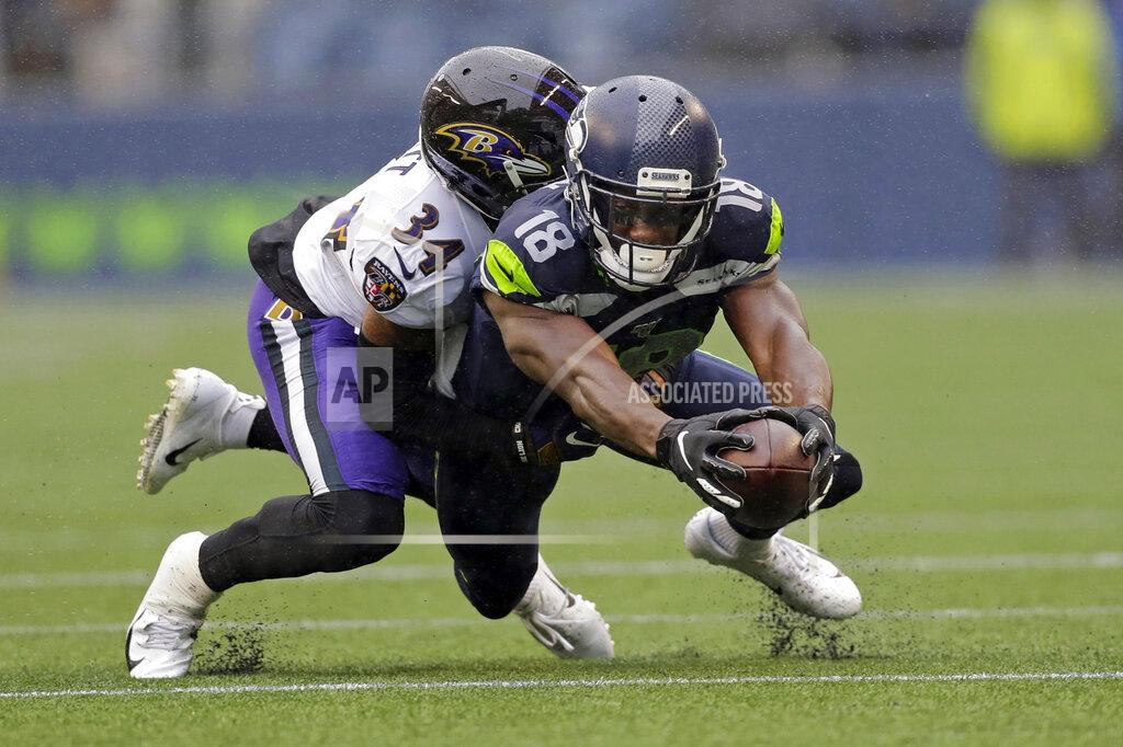 John Froschauer Seattle Seahawks wide receiver Jaron Brown (18) reaches for extra yardage as he is tackled by Baltimore Ravens cornerback Anthony Averett (34) during the first half of an NFL football game, Sunday, Oct. 20, 2019, in Seattle. (AP Photo/John Froschauer)