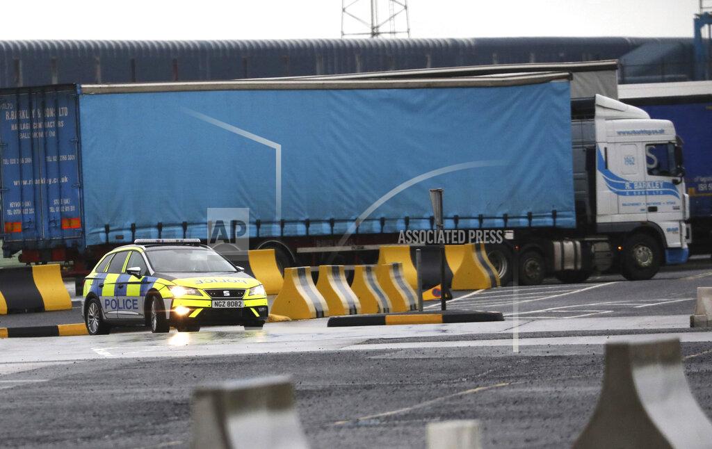 Peter Morrison Police patrol the port of Larne, Northern Ireland, Tuesday, Feb. 2, 2021. Authorities in Northern Ireland have suspended checks on animal products and withdrawn workers from two ports after threats against border staff. (AP Photo/Peter Morrison)