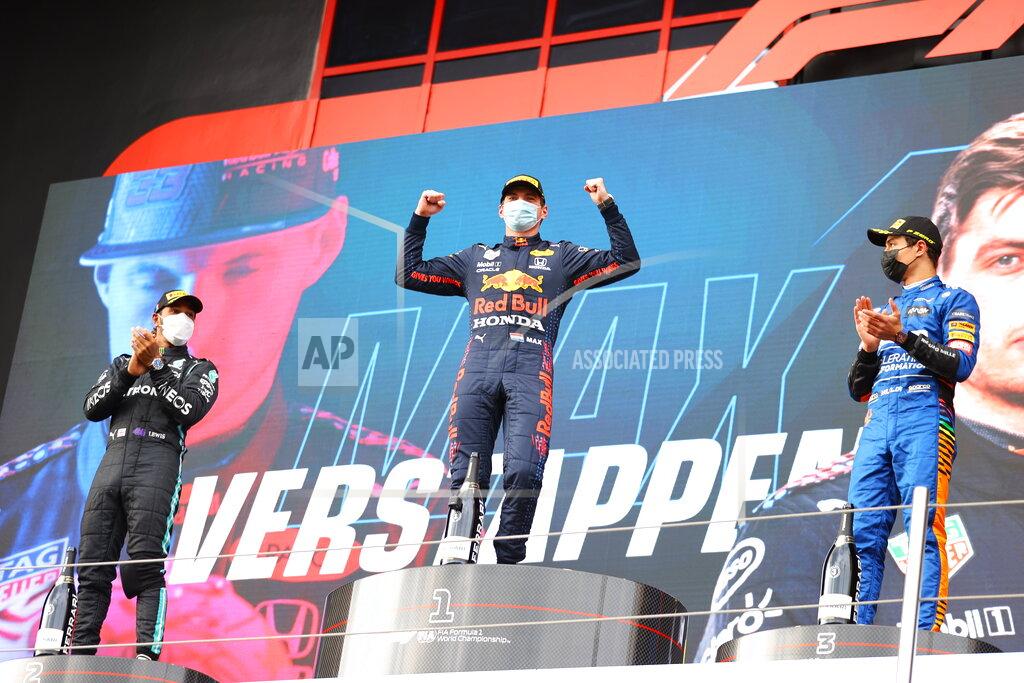 Bryn Lennon From left, second placed Mercedes Lewis Hamilton, first placed Red Bull's Max Verstappen and third placed McLaren's Lando Norris celebrate on the podium at the end of the Emilia Romagna Formula One Grand Prix, at the Imola racetrack, Italy, Sunday, April 18, 2021. (Bryn Lennon/ Pool Via AP)