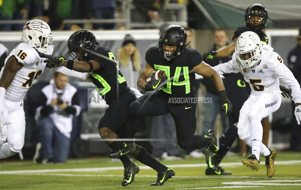 Chris Pietsch Oregon's CJ Verdell, center, breaks an Arizona State tackle on his way to a second quarter touchdown in an NCAA college football game Saturday, Nov. 17, 2018, in Eugene, Ore. (AP Photo/Chris Pietsch)