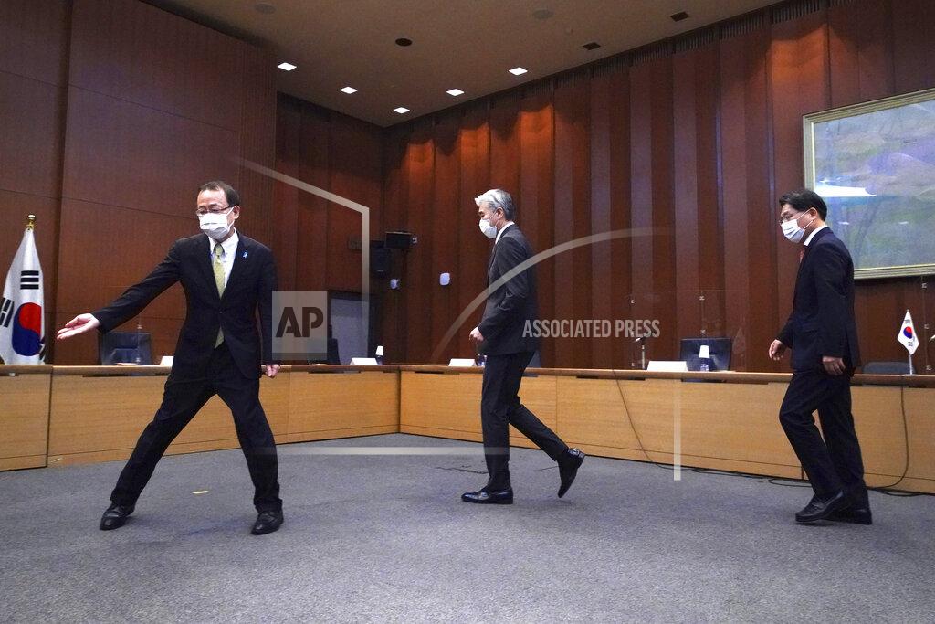 Eugene Hoshiko Japanese Foreign Ministry's Director-General of the Asian and Oceanian Affairs Bureau Takehiro Funakoshi, left, escorts U.S. Special Representative for North Korea, Sung Kim, center, and South Korea's Special Representative for Korean Peninsula Peace and Security Affairs Noh Kyu-duk for a photo session during their trilateral meeting on North Korea at Foreign Ministry Tuesday, Sept. 14, 2021 n Tokyo. (AP Photo/Eugene Hoshiko)