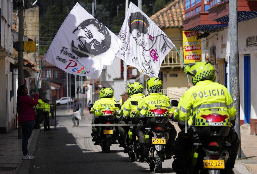 Fernando Vergara Supporters of Historical Pact coalition presidential candidate Gustavo Petro hold flags with the images of Petro and his running mate Francia Marquez before a closing campaign rally in Zipaquira, Colombia, Sunday, May 22, 2022. Elections are set for May 29. (AP Photo/Fernando Vergara)