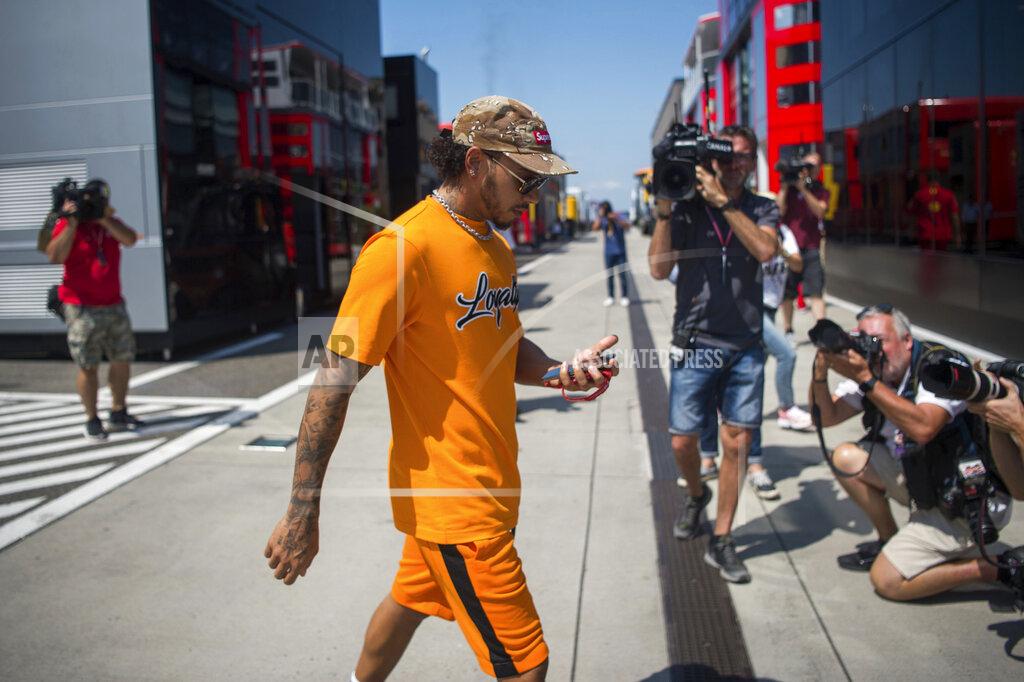 Zoltan Balogh British Formula One driver Lewis Hamilton of Mercedes AMG GP walks through the Hungaroring circuit in Mogyorod, Hungary, Thursday, Aug. 1, 2019. The Hungarian Formula One Grand Prix will take place on Aug. 4, 2019. (Zoltan Balogh/MTI via AP)
