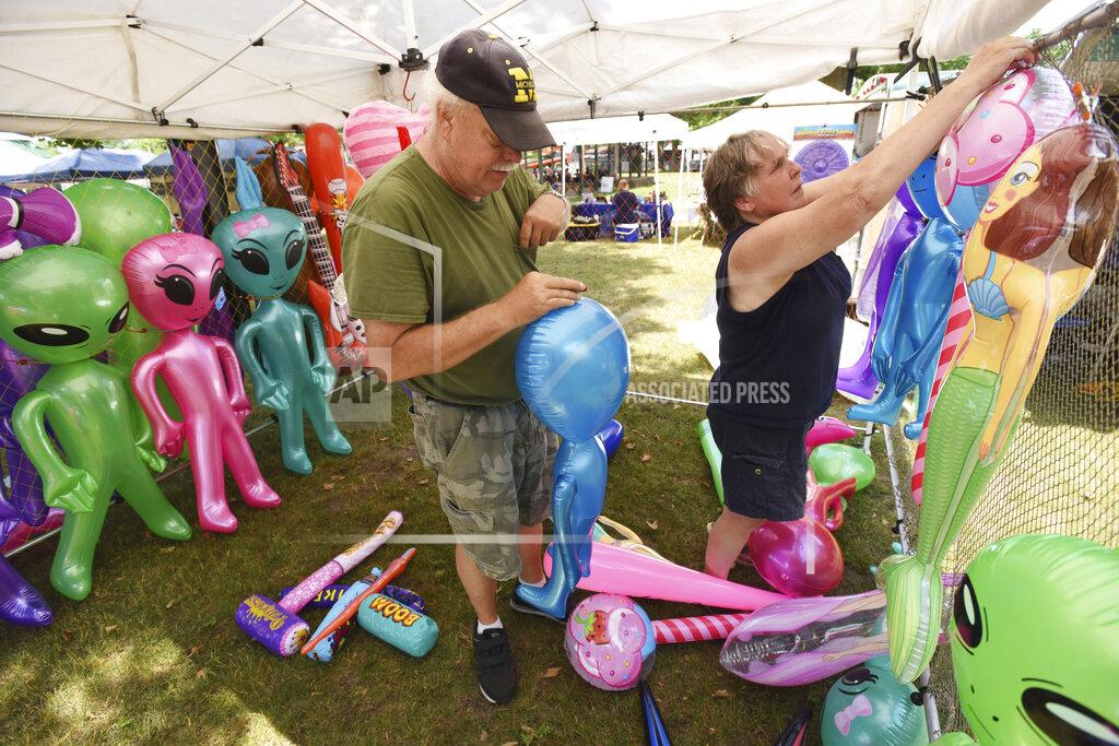 Don Campbell Vendors Milt and Chris Stainbrook, owners of C2 Treasures, set up their tent Friday, June 11, 2021, during the opening of the Hartford Strawberry Festival, held at Ely Park in downtown Hartford, Mich. The annual festival returned after being cancelled last year due to the pandemic.(Don Campbell/The Herald-Palladium via AP)