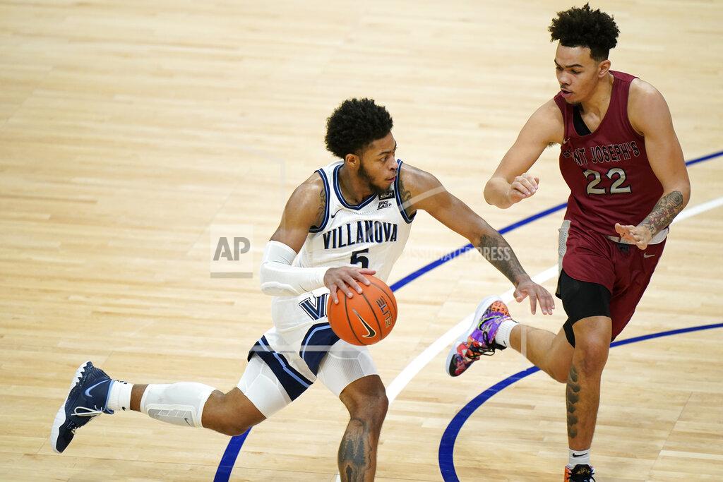 Matt Slocum Villanova's Justin Moore (5) drives against Saint Joseph's Jordan Hall (22) during the second half of an NCAA college basketball game, Saturday, Dec. 19, 2020, in Villanova, Pa. (AP Photo/Matt Slocum)