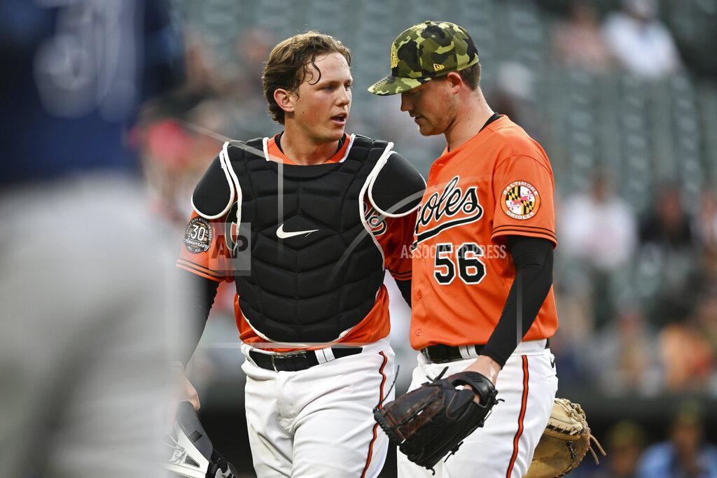 Gail Burton Baltimore Orioles catcher Adley Rutschman, left, talks with pitcher Kyle Bradish after the top of the second inning of the team's baseball game against the Tampa Bay Rays on Saturday, May 21, 2022, in Baltimore. (AP Photo/Gail Burton)