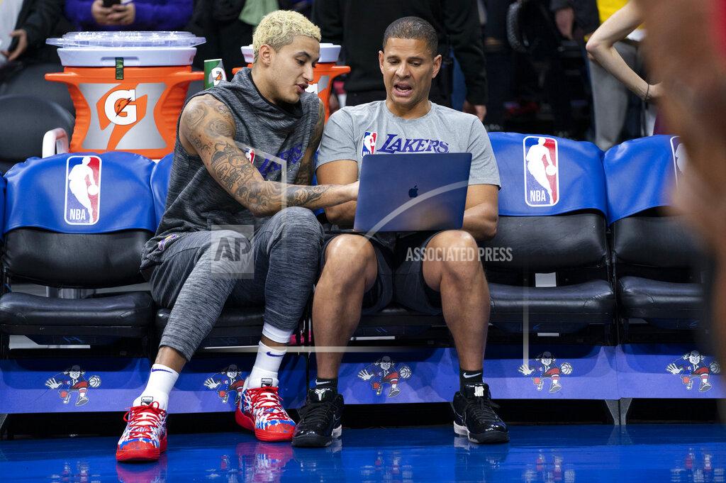 Chris Szagola FILE - In this Jan. 25, 2020, file photo, Los Angeles Lakers' Kyle Kuzma, left, looks over the computer with assistant coach Miles Simon, right, prior to the first half of an NBA basketball game against the Philadelphia 76ers in Philadelphia. Former Arizona All-America guard Miles Simon scored 30 points to help Arizona defeat Kentucky in the 1997 NCAA college basketball championship game. (AP Photo/Chris Szagola, Fle)