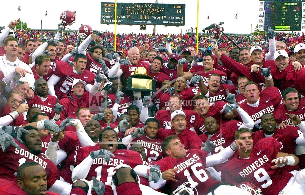 Lm Otero FILE - In this Oct. 7, 2000, file photo, members of the Oklahoma football team and coaches celebrate after beating Texas, 63-14, in Dallas. The decade started with Oklahoma’s last national title in 2000 and ended with Alabama’s undefeated championship run under Nick Saban in 2009. (AP Photo/LM Otero)